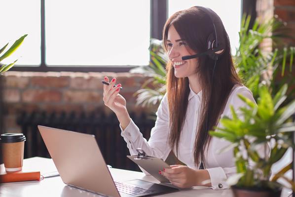 Customer Service Representative using phone headset and laptop