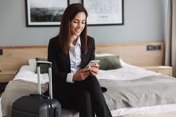 Hotel guest using her mobile phone