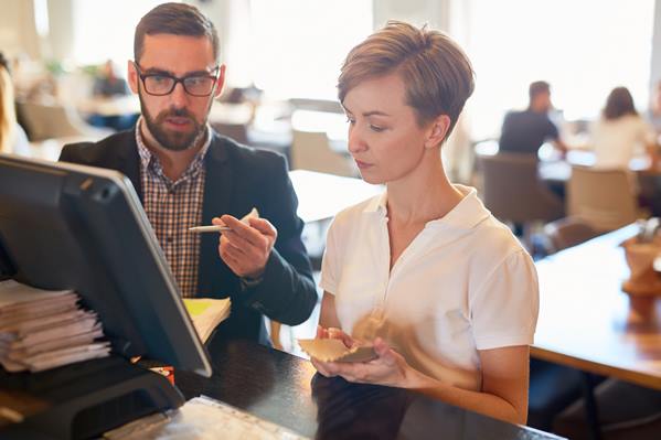 Restaurant manager talking to waitress