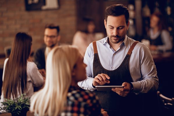 Stressed waiter in restaurant