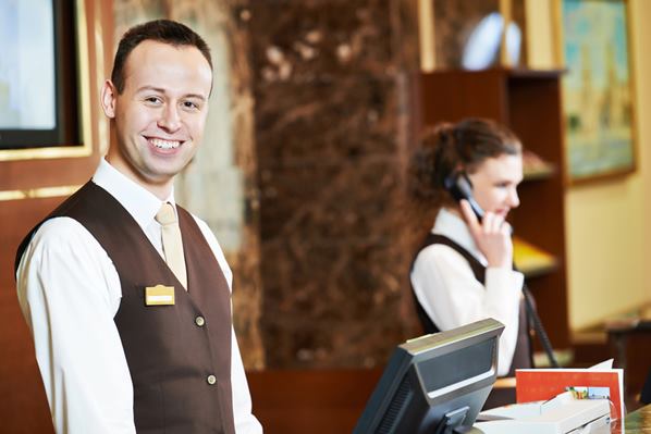 Hotel Manager and reception staff at the front desk