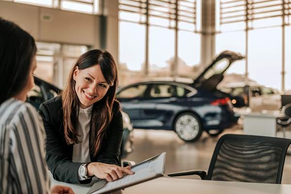 Car salesperson talking to customer